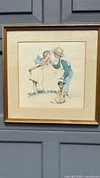 Full view of framed Norman Rockwell print in gold frame