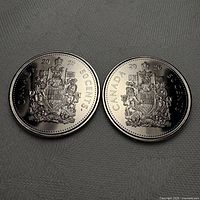 Pair of coins showing reverse with Canadian Coat of Arms