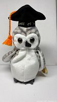 Front view of owl plush wearing graduation cap