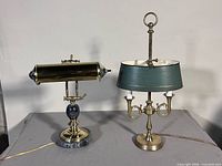 Front view of both brass desk lamps on tabletop