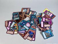 Pile of assorted trading cards spread on table