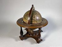 Full view of Old World wooden desk globe on turned tripod base