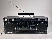 Front view of Sanyo M9716 boombox showing speakers, cassette deck, controls, antenna