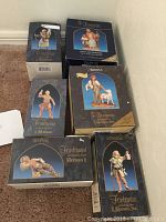 Six boxed Fontanini shepherd figurines arranged on carpet showing brand and series info on boxes.