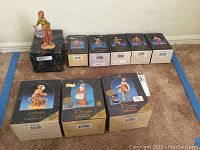 Nine boxed Fontanini villager figurines and one opened figure, showing set with original packaging mostly intact.