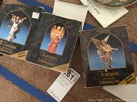 Three Fontanini angel figurine boxes for Erela, Leah, and Raphael shown upright on carpet showing front artwork and limited edition markings.