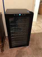 Black Vinotemp wine cooler showing front with glass door and control panel at the top.