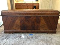 Full front view of closed cedar chest showing geometric veneer pattern and hinged lid