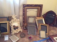 Assortment of 10+ wood and metal frames with various decorations and sizes around 3x3 to 18x16