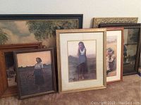 Seven various framed art prints arranged on floor, showing overall lot contents