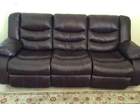 Full front view of three-seat brown leather sofa
