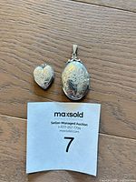 Both lockets closed side by side for size reference