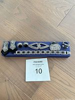 All eight jewellery pieces arranged on blue holder