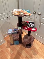 Cat tree with magazines, hat, stockings, magnets, card deck visible