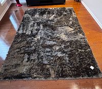 Full view of rug showing shag texture and color variation