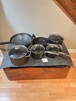 All cookware pieces arranged together on mat