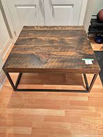Top view of square wood and metal coffee table