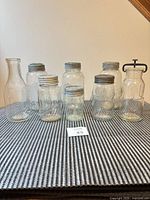 Eight assorted vintage glass jars and bottles