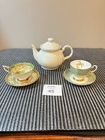 Overall lot showing teapot and two teacup-saucer sets