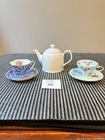 Group shot: two teacup-saucer sets and teapot