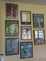 Front view showing all eight framed sheet-music advertisements on wall
