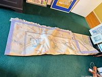 Rug rolled lengthwise showing size and fringe