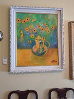 full view of framed floral oil painting on wall