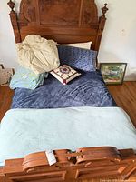 Full size bed with multiple pillows and blankets