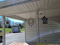 Full view of all three hanging items under porch roof