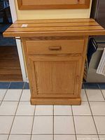 Front view of butcher block cabinet with drawer and door closed