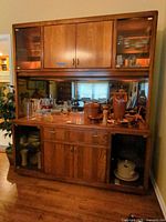 Full view of the wood lighted china cabinet showing upper glass display and lower storage