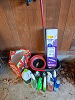 Full lot view showing boxed Power Mop, bucket, mop handle, spray cleaners, gallon jug and tote