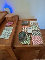 Overview of all coasters and glass vase on table