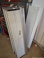 Stack of EZ Cuts trimmers showing gridded cutting surface and aluminum frames