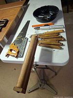 Overview of chisels, saw, level, roller stand top