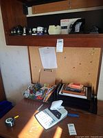Desk with printing calculator, letter trays, upper shelf of staplers