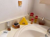 All seven perfume bottles on countertop showing shapes, sizes and fill levels