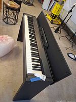 Front angled view of entire Casio Privia piano on stand