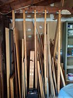 Front view of stacked scrap wood pieces leaning against wall