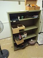 Front view of metal shelving unit with shelves and open front