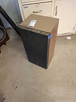 Free-standing Technics SB-L56 speaker showing front grille and cabinet