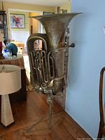 Full view of tuba on stand