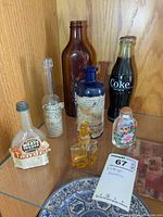 Group shot of all seven vintage bottles on shelf