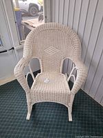 Full view of white wicker rocking chair