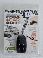 Front view of sealed Universal Car Remote package showing remote and compatibility list