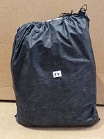 black drawstring bag containing inflatable mattress set