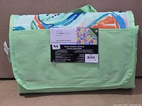 Folded Mainstays blanket showing carry handle and front label
