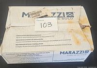 Marazzi branded cardboard box, sealed, showing product and installation details