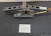 Top view of black steel scissor jack showing screw mechanism and lifting saddle