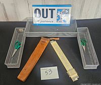 All items laid out: slide rule in sheath, three mesh trays, two scissors, desk sign